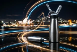 Cream charger and dispenser with dynamic light trails on reflective surface
