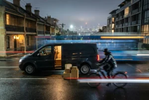 Courier van on a rainy Sydney street at night