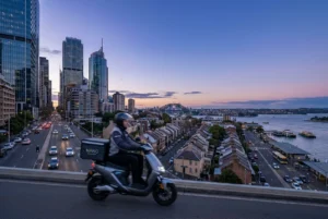 Sydney cityscape at dusk with a delivery rider in motion